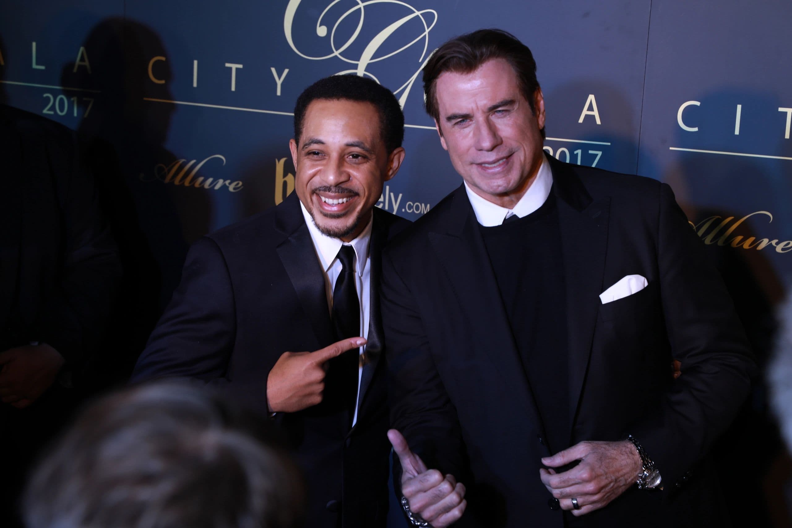 Two men in tuxedos on a gala red carpet