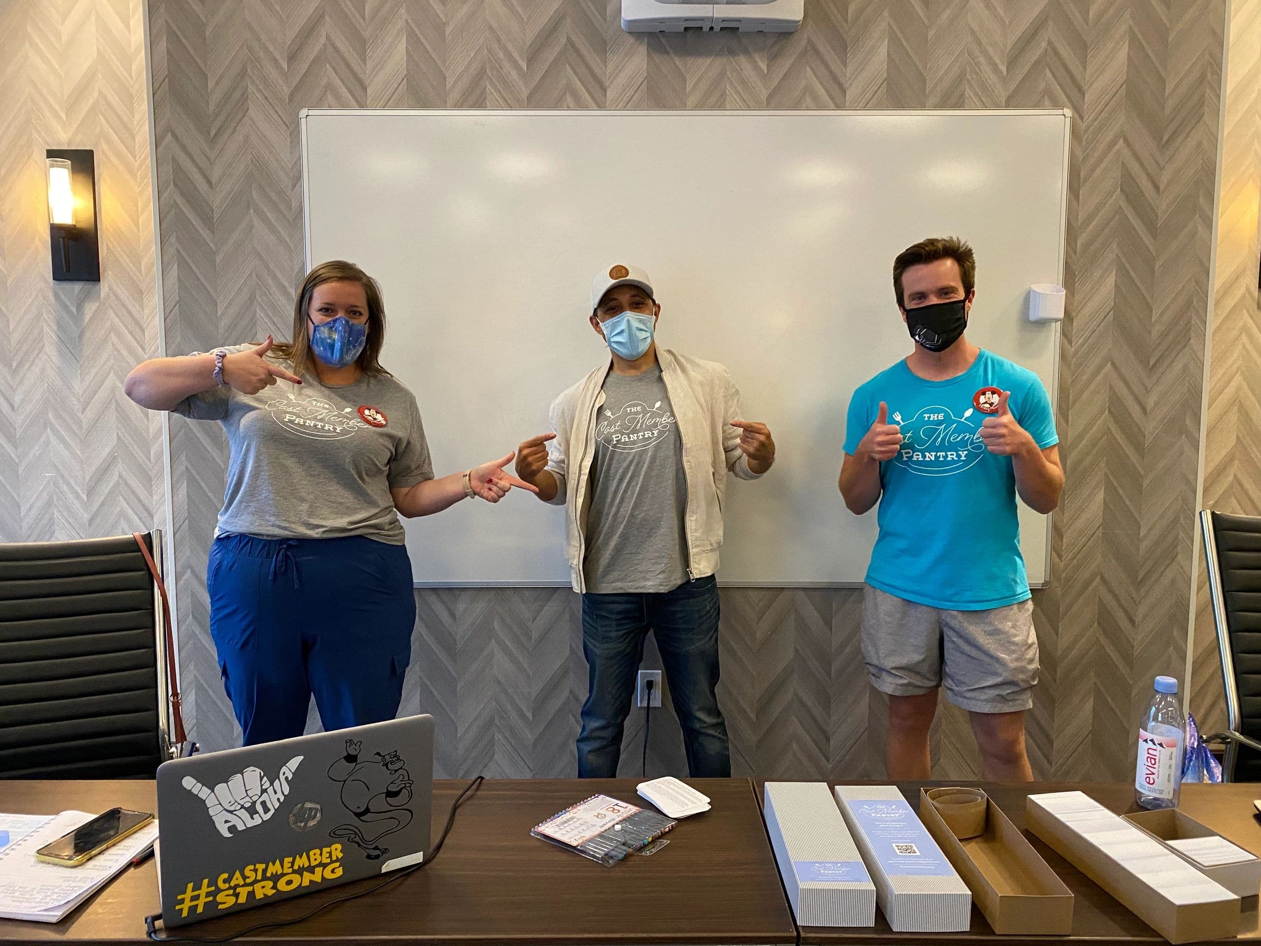 Three volunteers in matching charity shirts