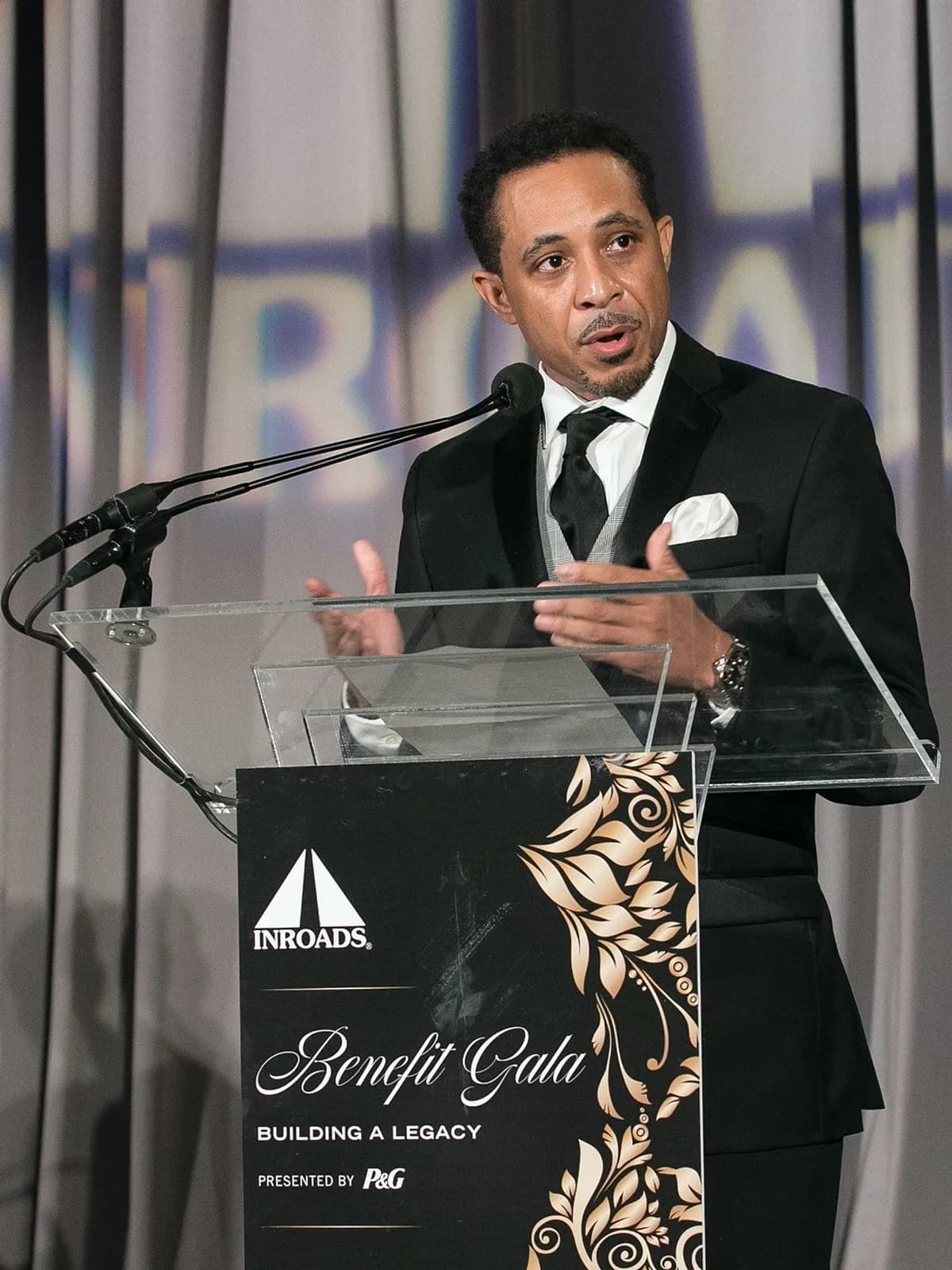 Dale Godboldo speaking at a podium at the INROADS Benefit Gala